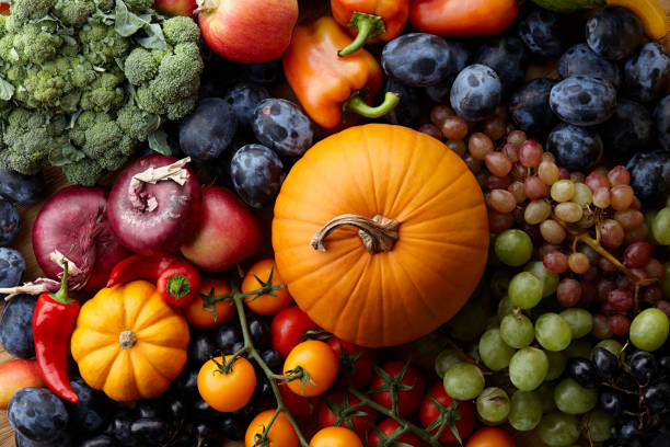 Autumn+harvest+concept.+Seasonal+fruits+and+vegetables+on+a+wooden+table%2C+top+view
